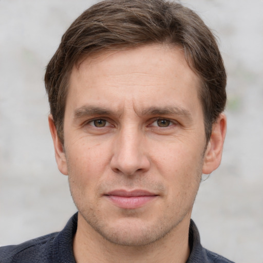 Joyful white adult male with short  brown hair and grey eyes