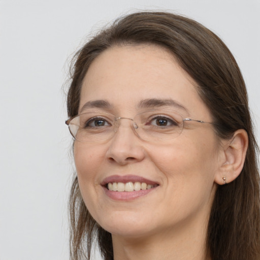 Joyful white adult female with long  brown hair and brown eyes