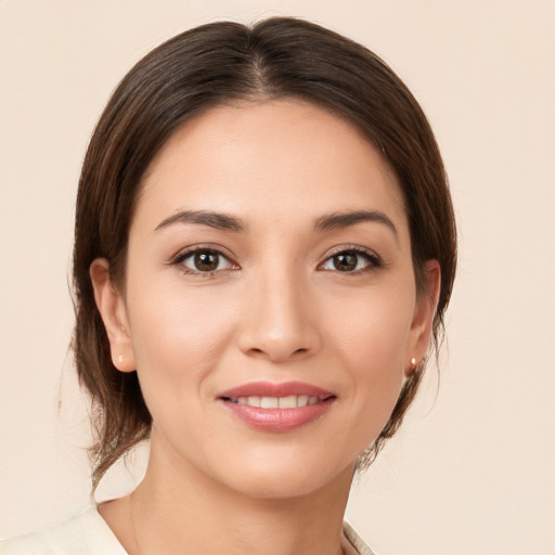 Joyful white young-adult female with medium  brown hair and brown eyes