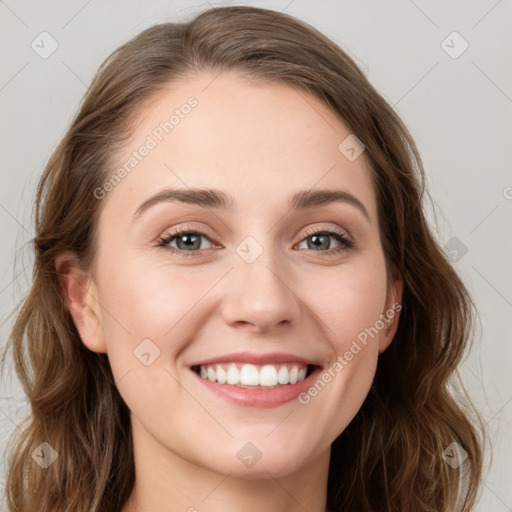 Joyful white young-adult female with long  brown hair and green eyes