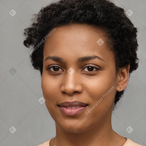 Joyful black young-adult female with short  black hair and brown eyes