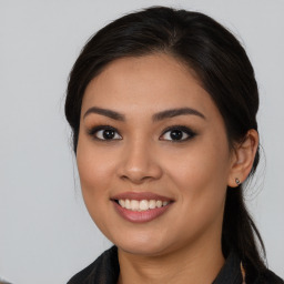 Joyful asian young-adult female with long  brown hair and brown eyes