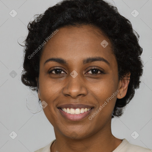 Joyful black young-adult female with short  black hair and brown eyes