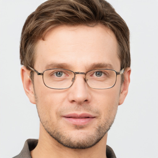 Joyful white adult male with short  brown hair and grey eyes