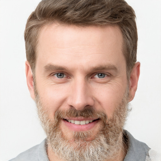 Joyful white adult male with short  brown hair and grey eyes