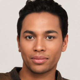 Joyful latino young-adult male with short  black hair and brown eyes