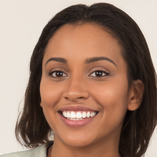 Joyful white young-adult female with long  brown hair and brown eyes