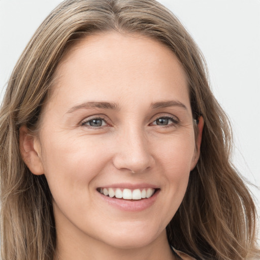 Joyful white young-adult female with long  brown hair and grey eyes