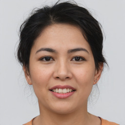 Joyful asian young-adult female with medium  brown hair and brown eyes