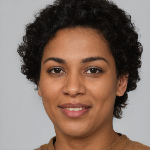Joyful latino young-adult female with short  black hair and brown eyes