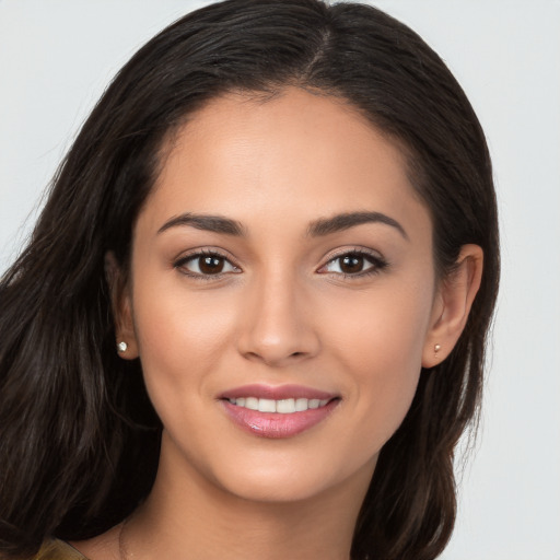 Joyful white young-adult female with long  brown hair and brown eyes