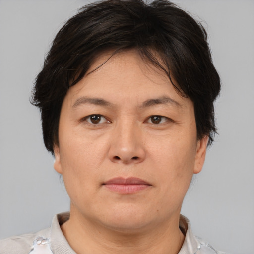 Joyful asian adult female with short  brown hair and brown eyes