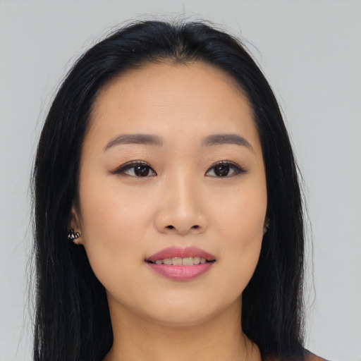 Joyful asian young-adult female with long  black hair and brown eyes