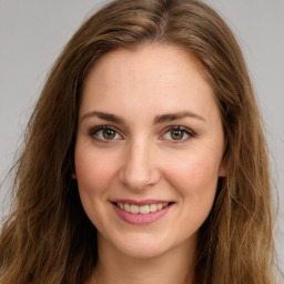 Joyful white young-adult female with long  brown hair and green eyes