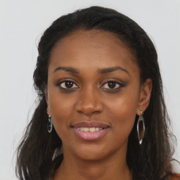 Joyful black young-adult female with long  brown hair and brown eyes