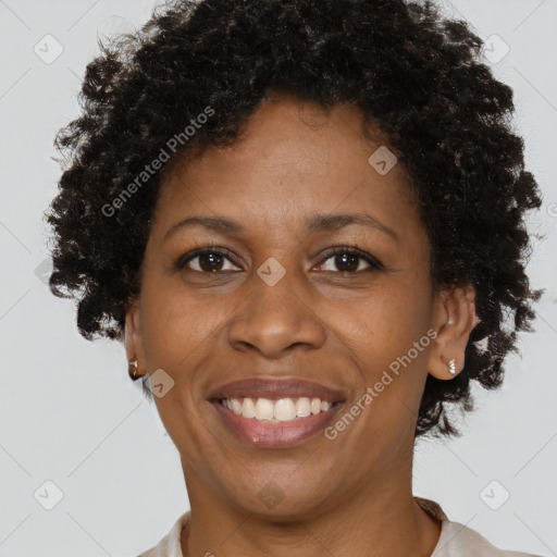 Joyful black adult female with short  brown hair and brown eyes