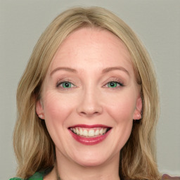 Joyful white young-adult female with long  brown hair and green eyes