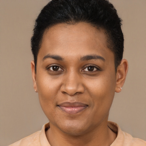 Joyful black young-adult female with short  brown hair and brown eyes