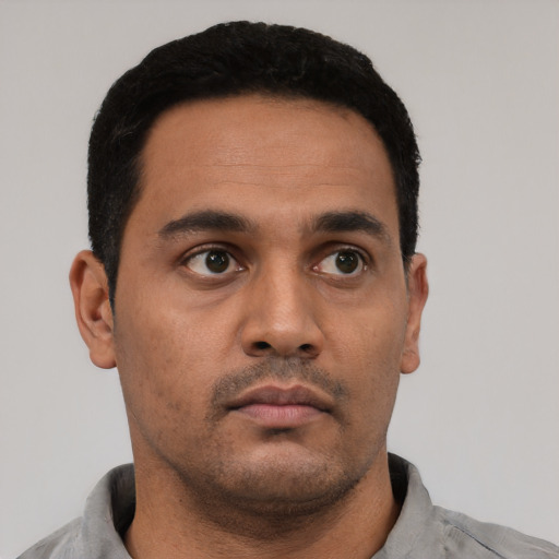 Neutral latino young-adult male with short  black hair and brown eyes