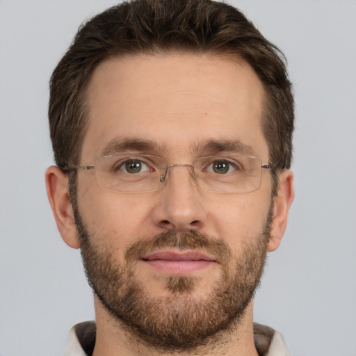 Joyful white adult male with short  brown hair and brown eyes