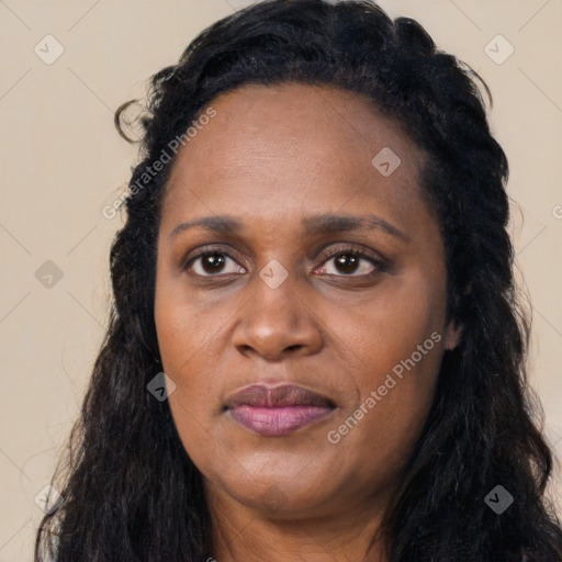 Joyful black adult female with long  black hair and brown eyes