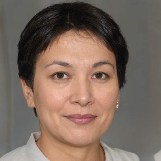 Joyful white adult female with short  brown hair and brown eyes