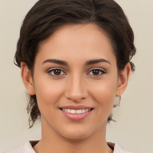 Joyful white young-adult female with medium  brown hair and brown eyes