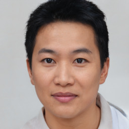 Joyful asian young-adult male with short  black hair and brown eyes