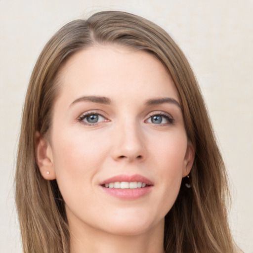 Joyful white young-adult female with long  brown hair and grey eyes