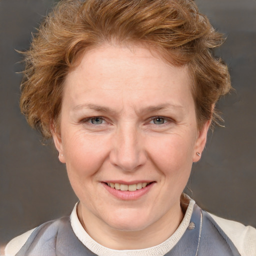 Joyful white adult female with short  brown hair and blue eyes