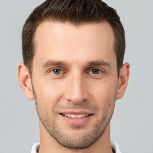 Joyful white young-adult male with short  brown hair and brown eyes