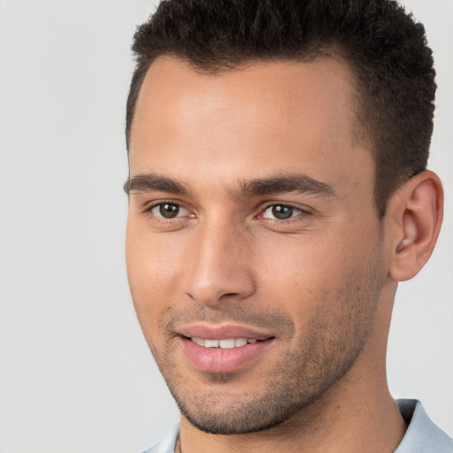 Joyful white young-adult male with short  brown hair and brown eyes