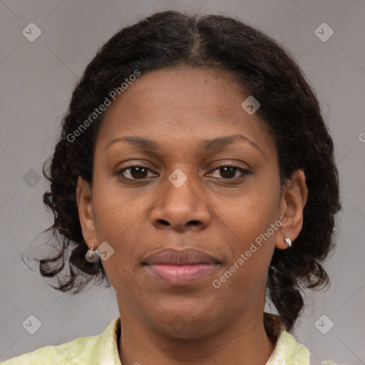 Joyful black adult female with medium  brown hair and brown eyes