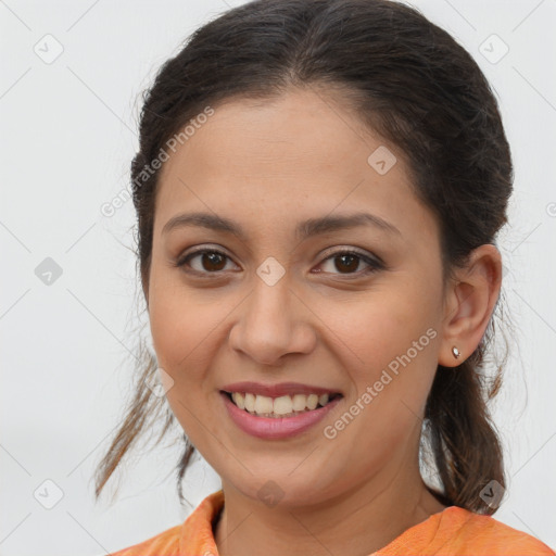 Joyful white young-adult female with medium  brown hair and brown eyes