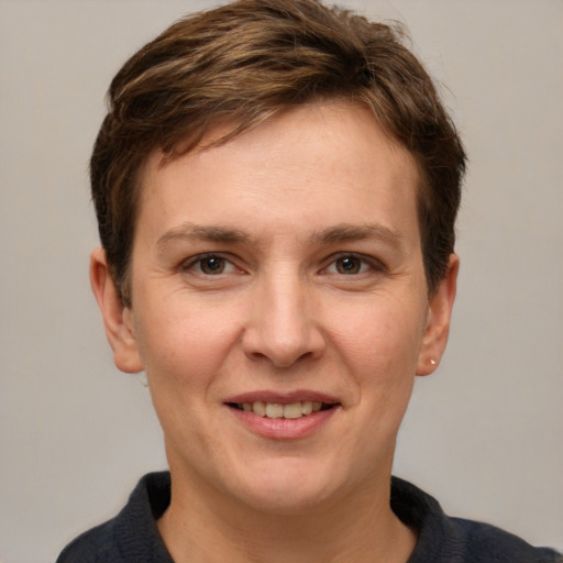 Joyful white young-adult female with short  brown hair and grey eyes