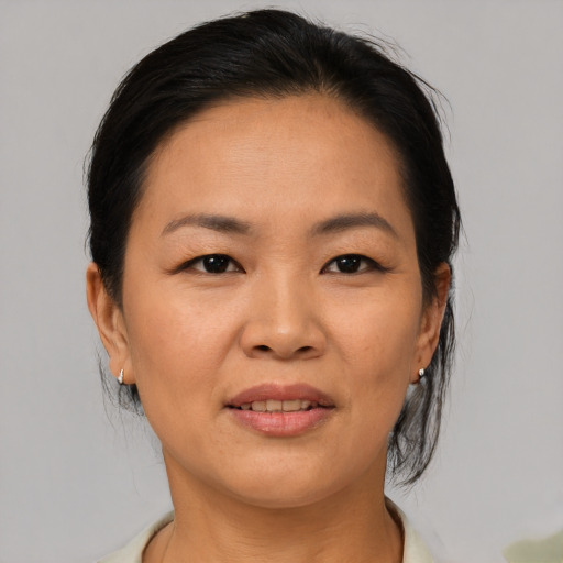 Joyful asian adult female with medium  brown hair and brown eyes
