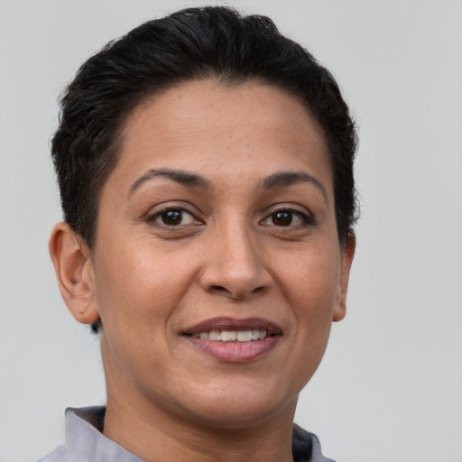 Joyful white adult female with short  brown hair and brown eyes