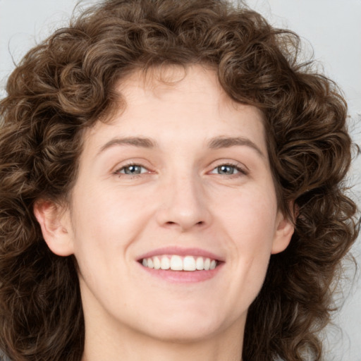 Joyful white young-adult female with medium  brown hair and green eyes