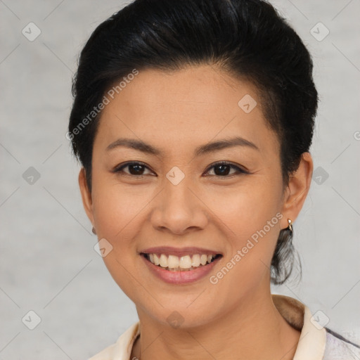 Joyful asian young-adult female with short  black hair and brown eyes