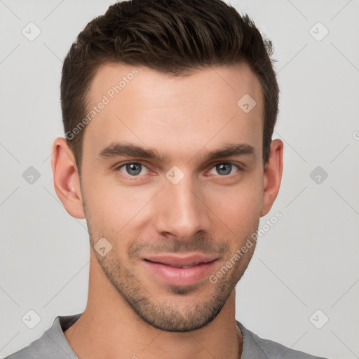 Joyful white young-adult male with short  brown hair and brown eyes