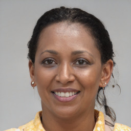 Joyful black adult female with short  brown hair and brown eyes