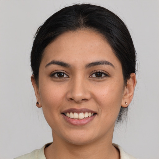 Joyful latino young-adult female with medium  brown hair and brown eyes