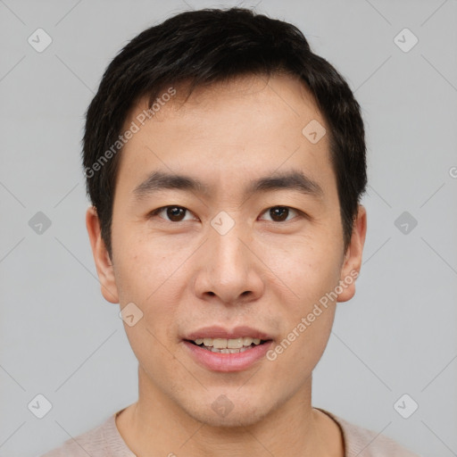 Joyful asian young-adult male with short  brown hair and brown eyes