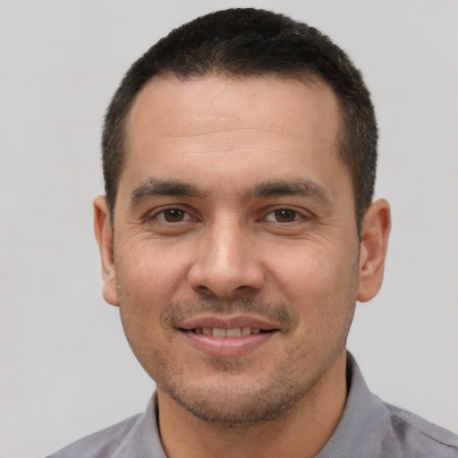 Joyful white young-adult male with short  brown hair and brown eyes