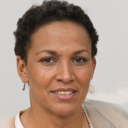 Joyful black adult female with short  brown hair and brown eyes