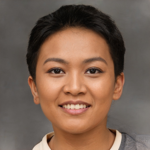 Joyful latino young-adult female with short  black hair and brown eyes