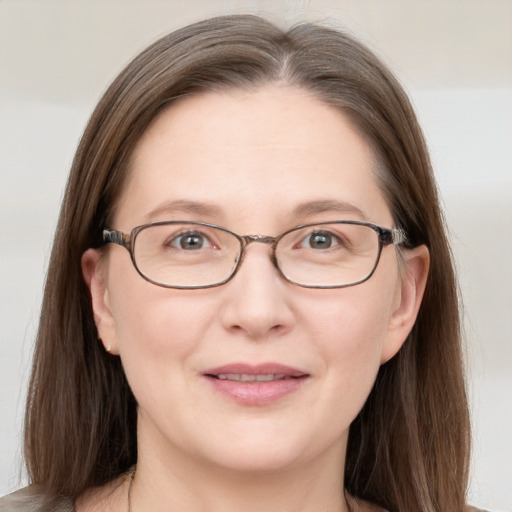 Joyful white adult female with long  brown hair and grey eyes