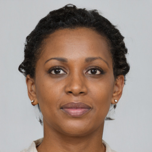 Joyful black adult female with short  brown hair and brown eyes