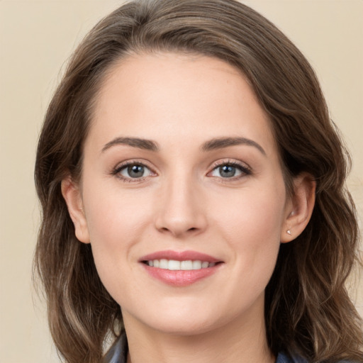 Joyful white young-adult female with long  brown hair and grey eyes