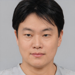 Neutral asian young-adult male with short  brown hair and brown eyes